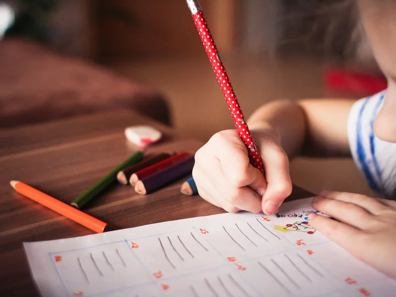 A child colouring with pencils